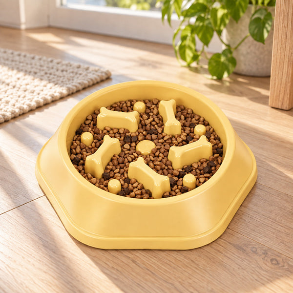 Yellow slow feeder bowl filled with kibble on a wooden floor